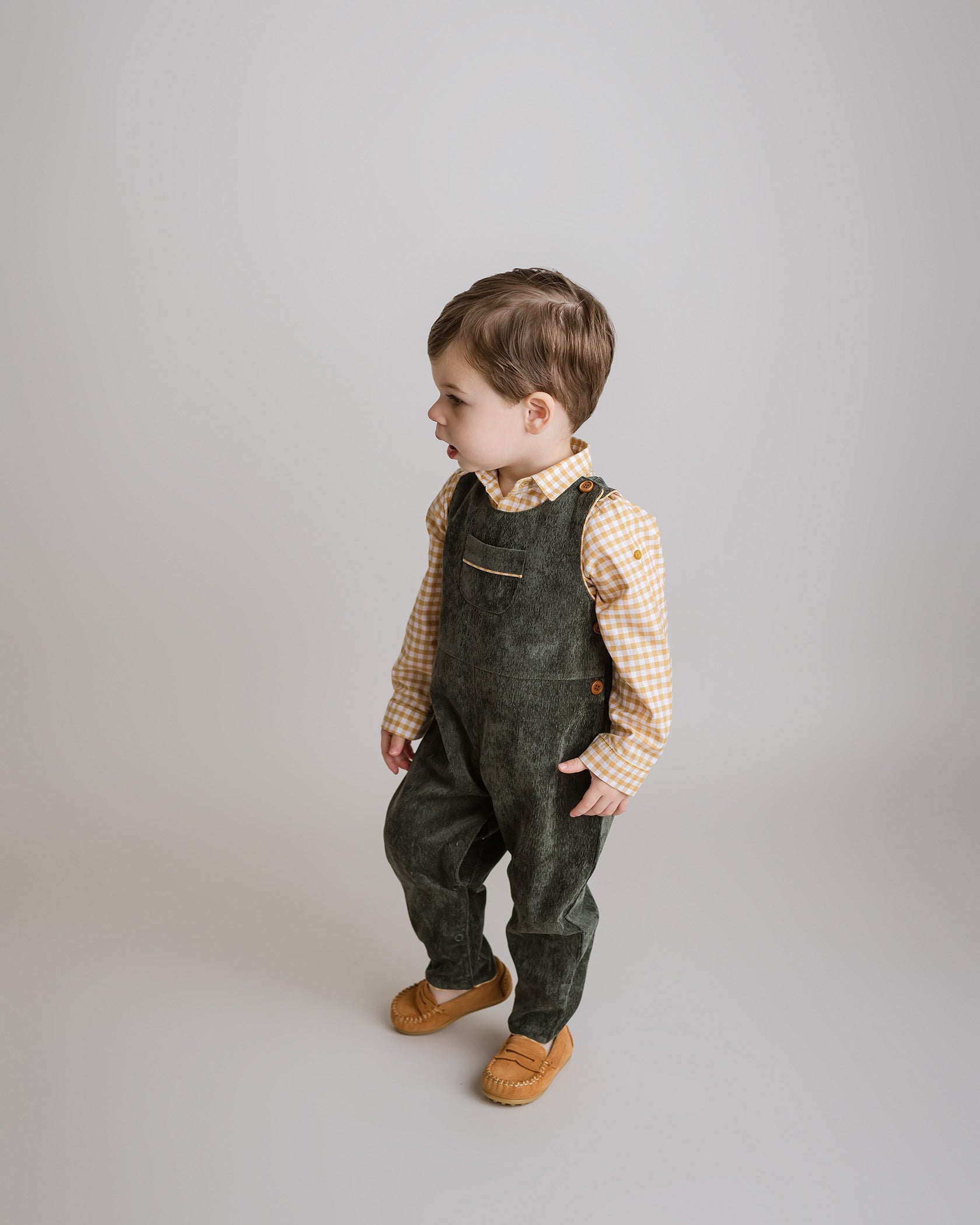 Elegant Forest Green Corduroy Boy Overalls with yellow gingham trim and wooden buttons, ideal for stylish fall and holiday wear by Cuclie