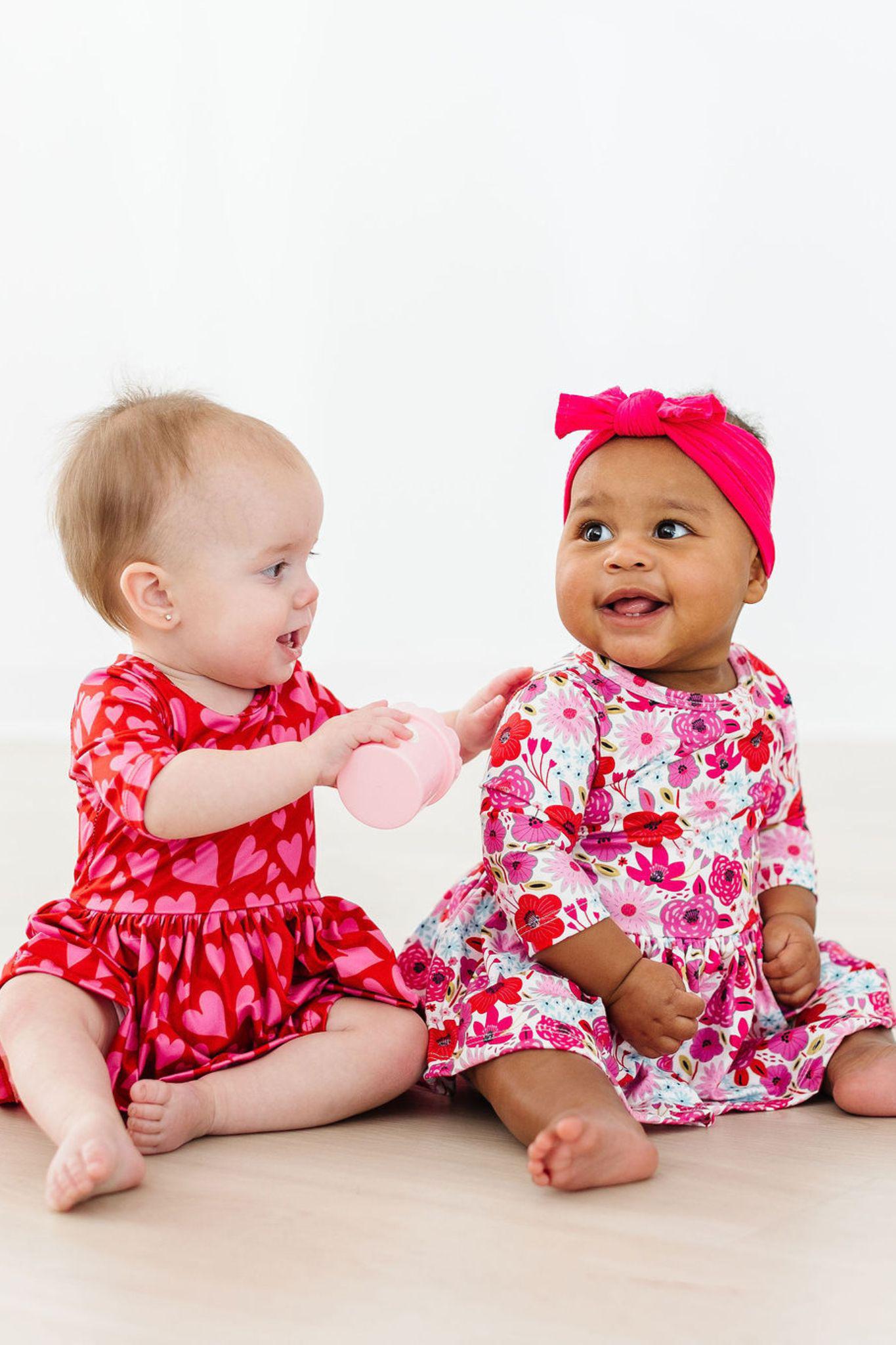 Baby girl wearing Secret Garden floral twirl bodysuit for photos or play

