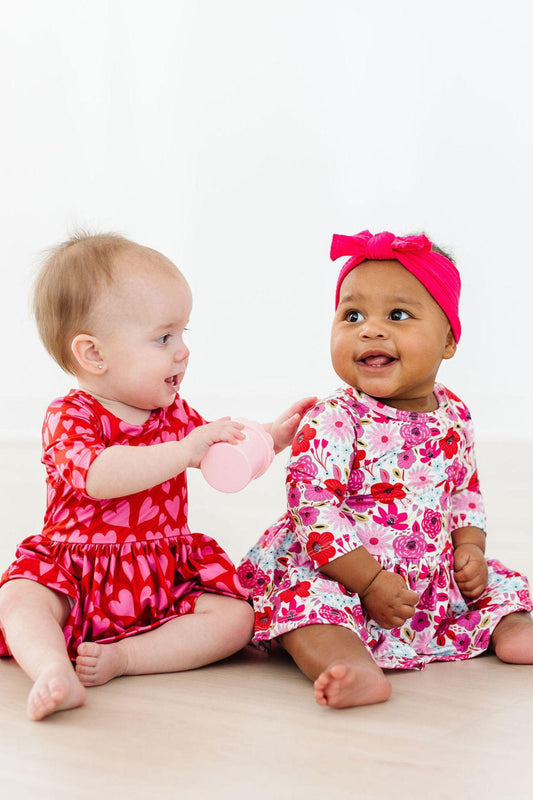 Baby girl wearing Secret Garden floral twirl bodysuit for photos or play

