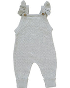 Knitted baby romper with ruffled straps on a white background