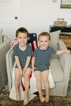 children wearing navy striped bamboo toddler short set at home