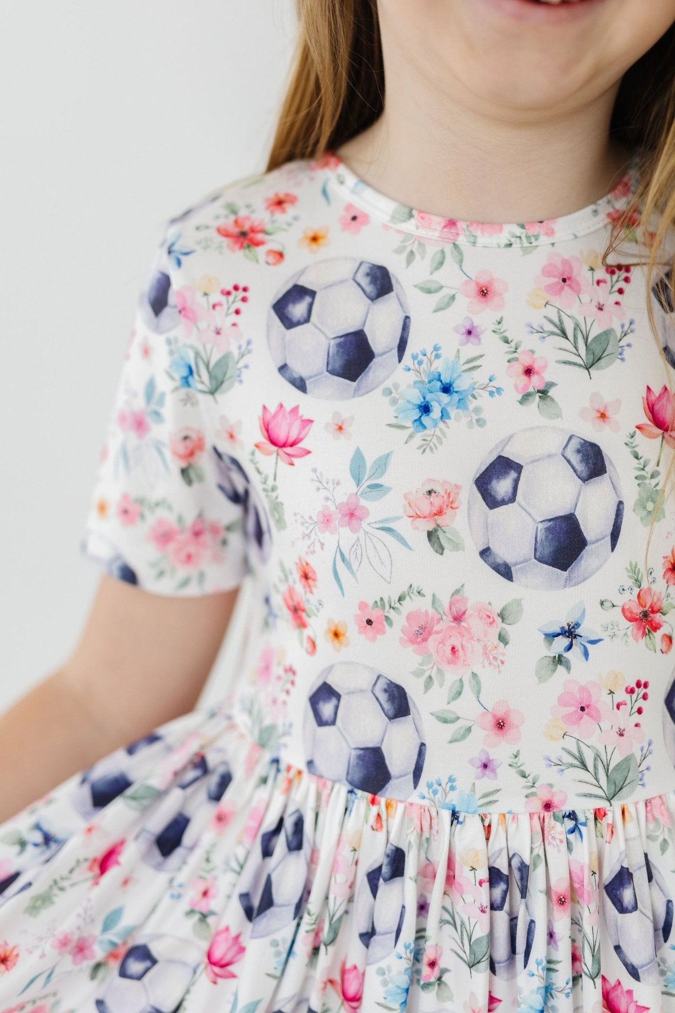 girl wearing soccer-themed twirl dress close up 