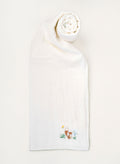 White towel with embroidered design on a white background
