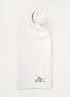 White towel with embroidered design on a white background
